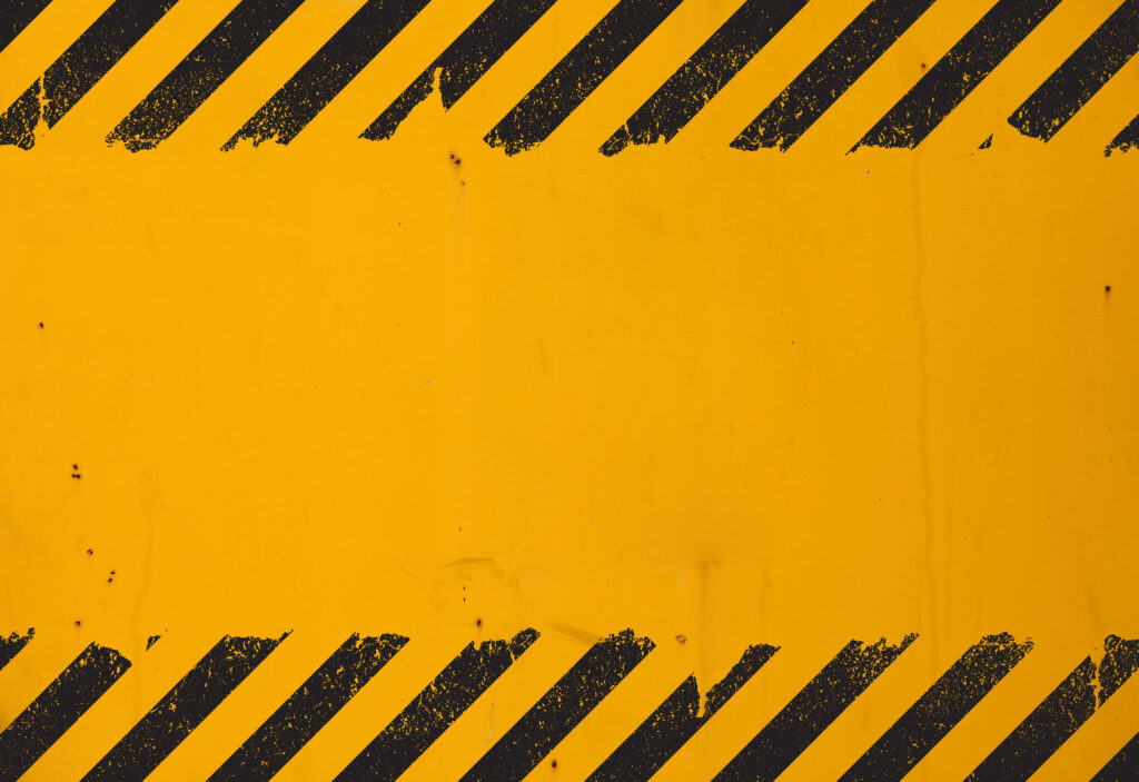 Yellow background with black grunge hazard sign