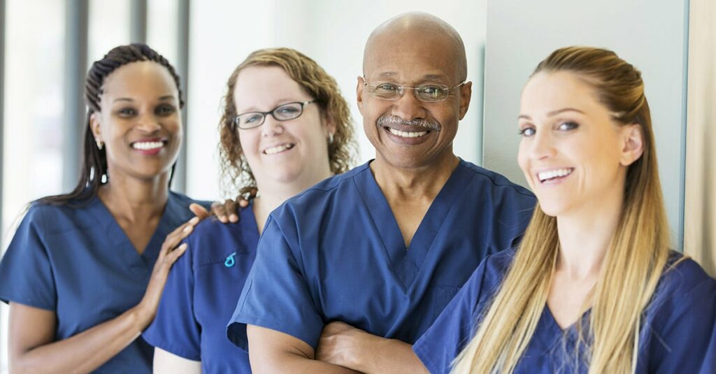 Man leading team of multi-ethnic medical professionals