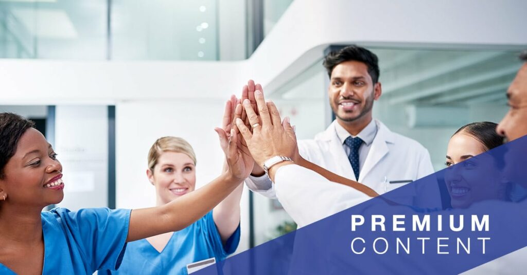 Diverse team of doctors giving each other a high five in a hospital