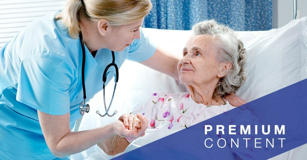 Nurse cares for a elderly patient lying in bed in hospital