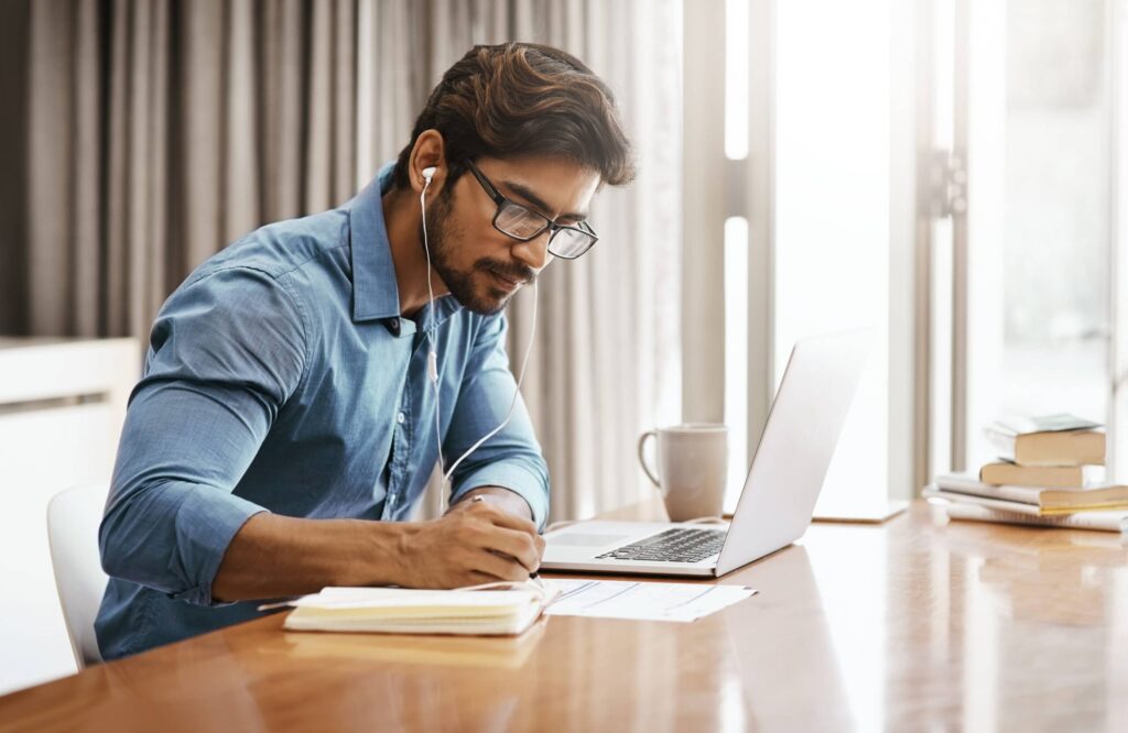 A young businessman working on his laptop in the office at home