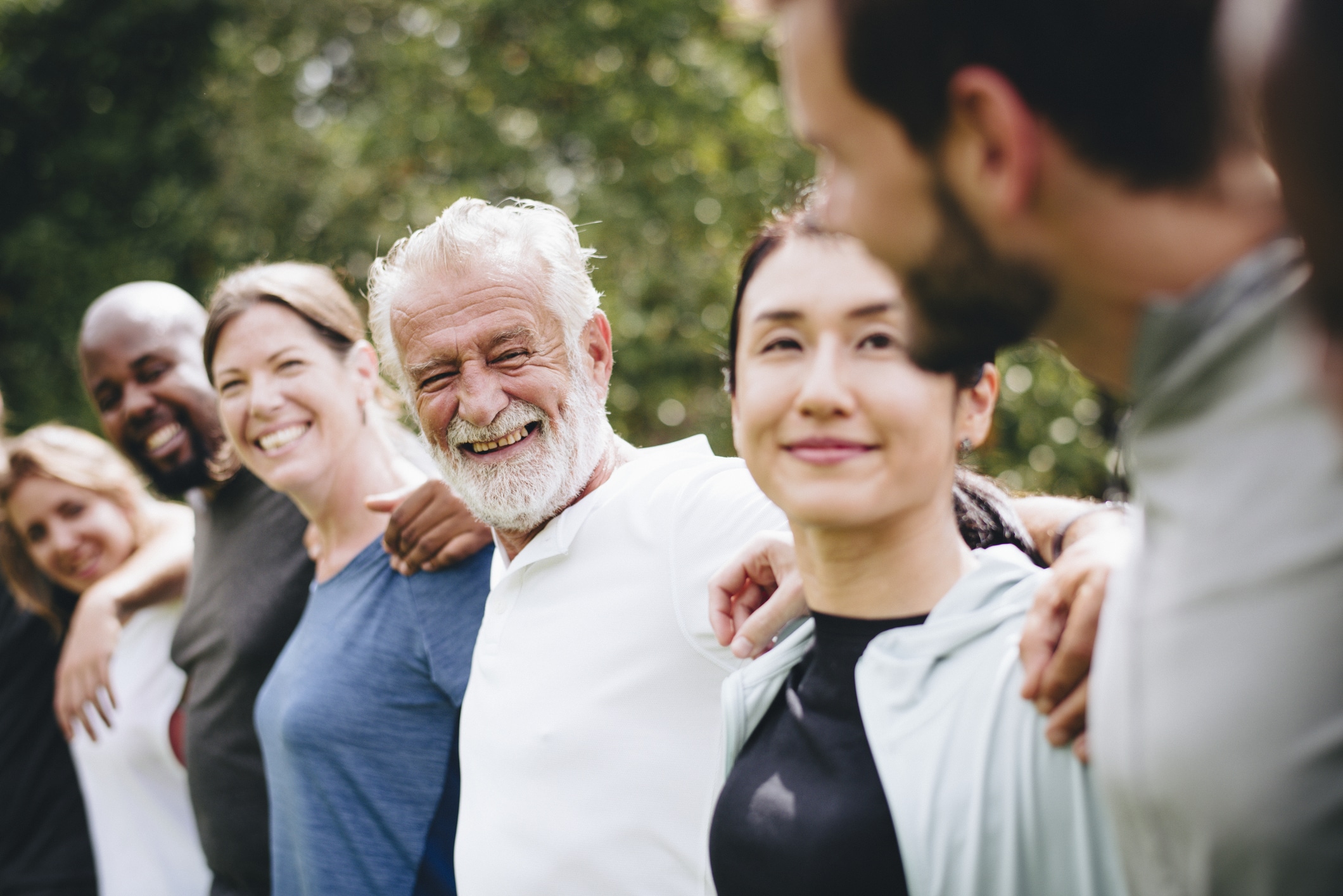 Group of community members happily standing in a row