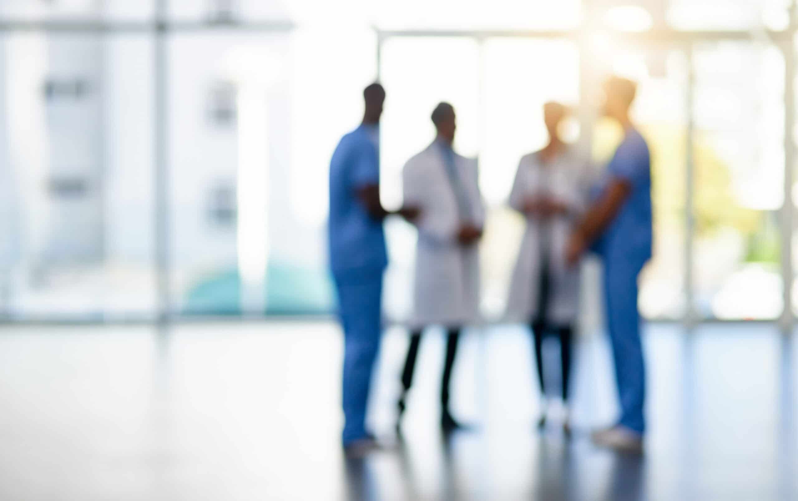 Blurred shot of a team of doctors standing together in a hospital