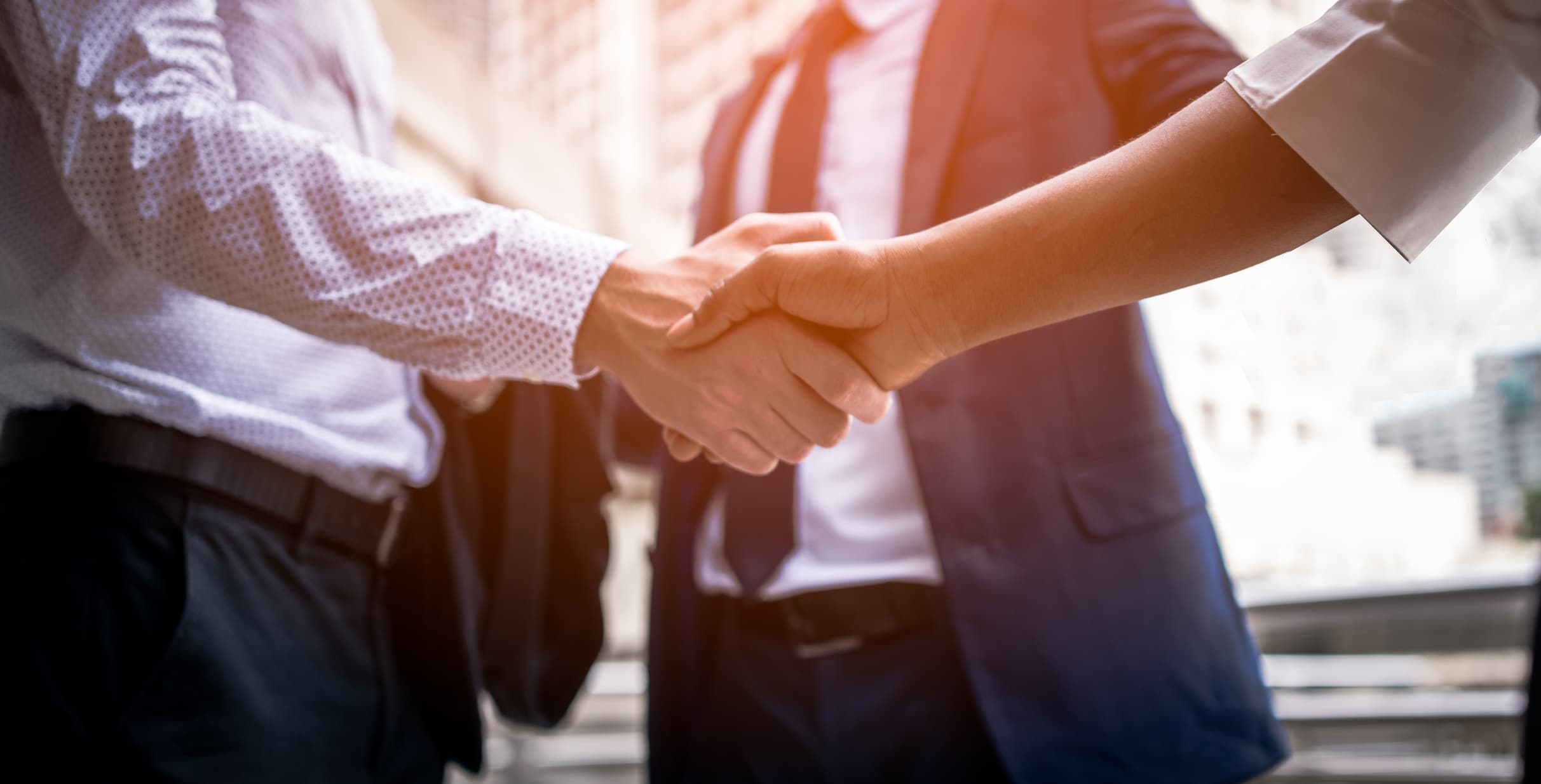 Healthcare leader shaking hands with consultant to begin work on an organization’s brand