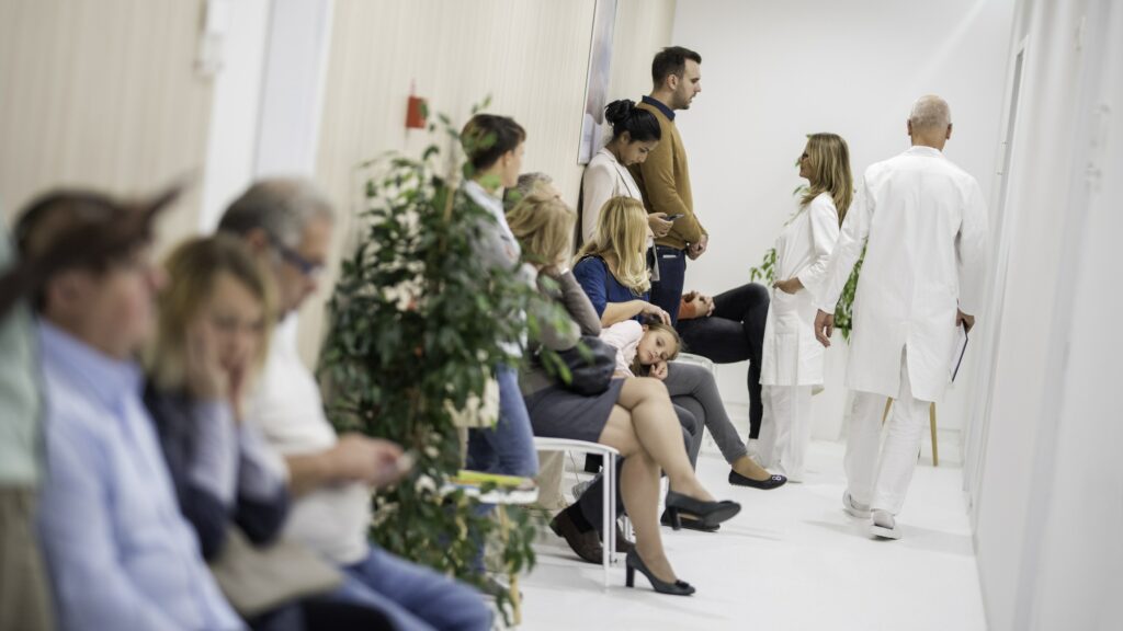 Group of people waiting in emergency room hallway