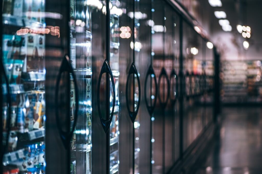 Aisle of refrigerated goods in grocery store