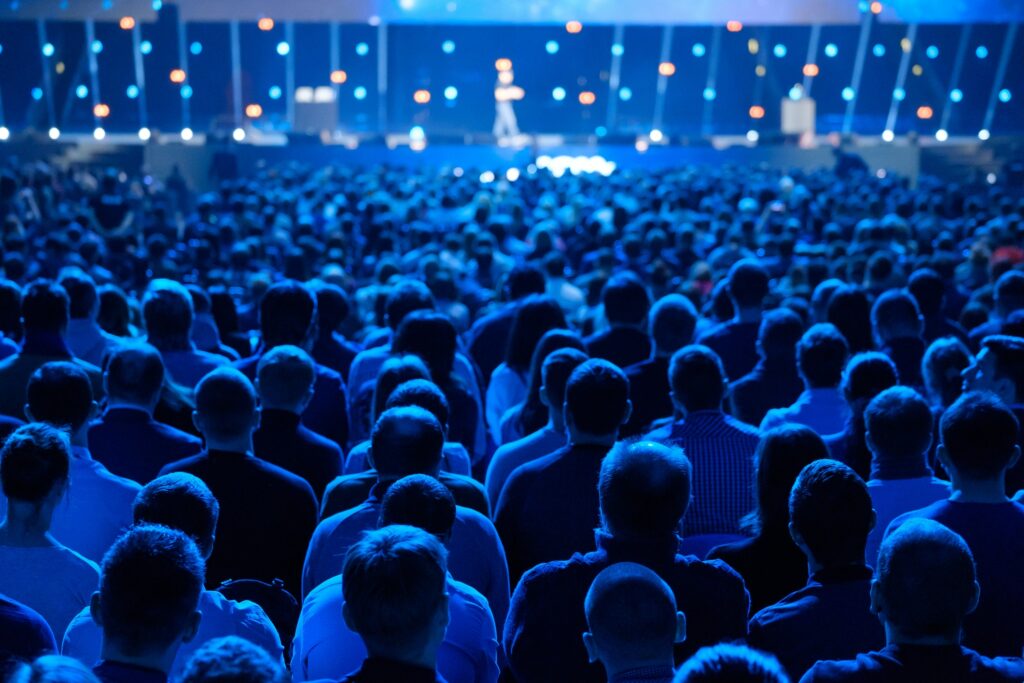 Crowd of people gathered for presentation at a conference