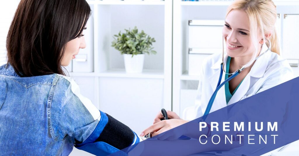 Doctor smiles as she takes the blood pressure of a patient