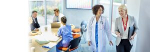 Female doctor and consultant enthusiastically discuss Healthcare Differently after reviewing organizational research
