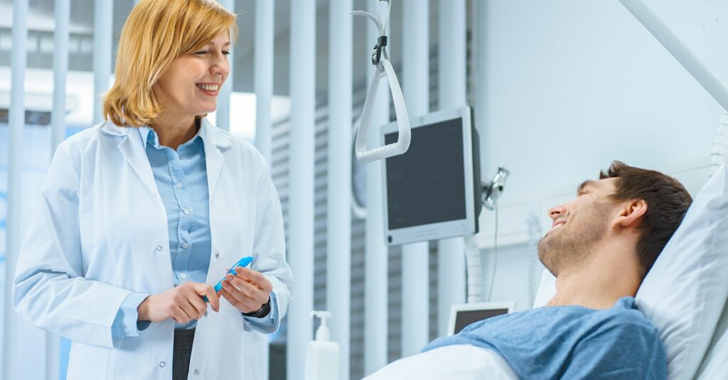 Doctor speaking to patient during inpatient hospital care