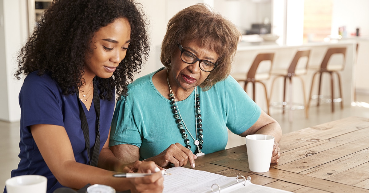 Healthcare professional discussing care options with aging female