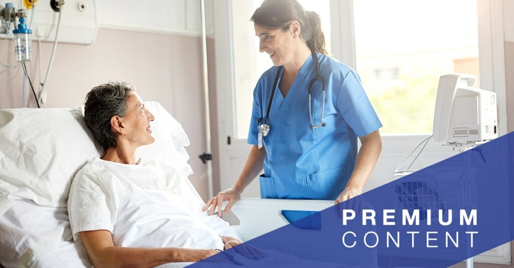 Nurse speaking to patient in hospital bed