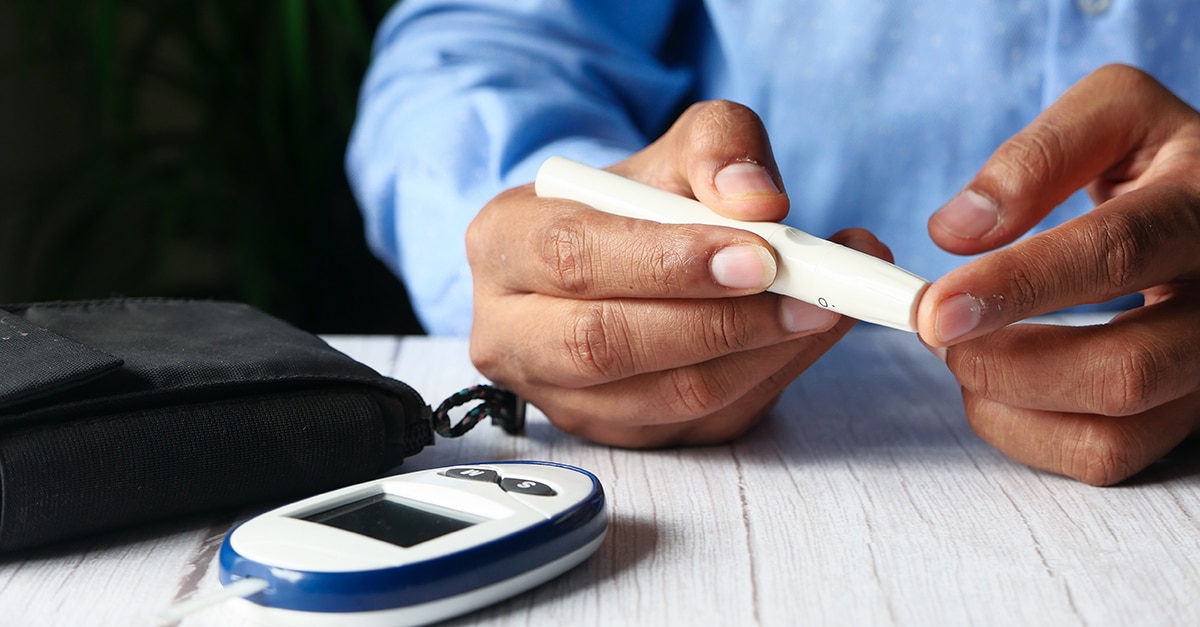 Person with diabetes measuring blood sugar level