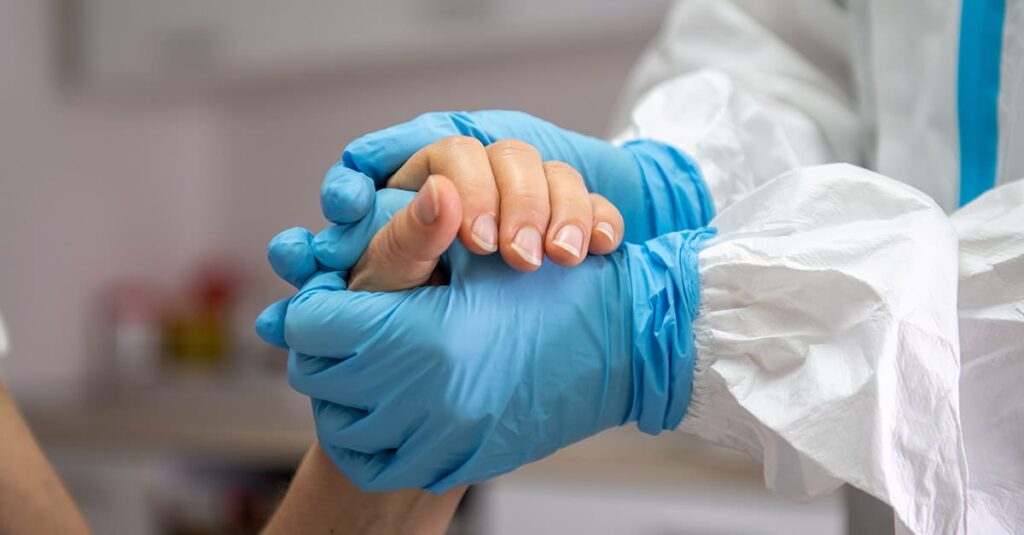 Healthcare worker caring for COVID patient in PPE