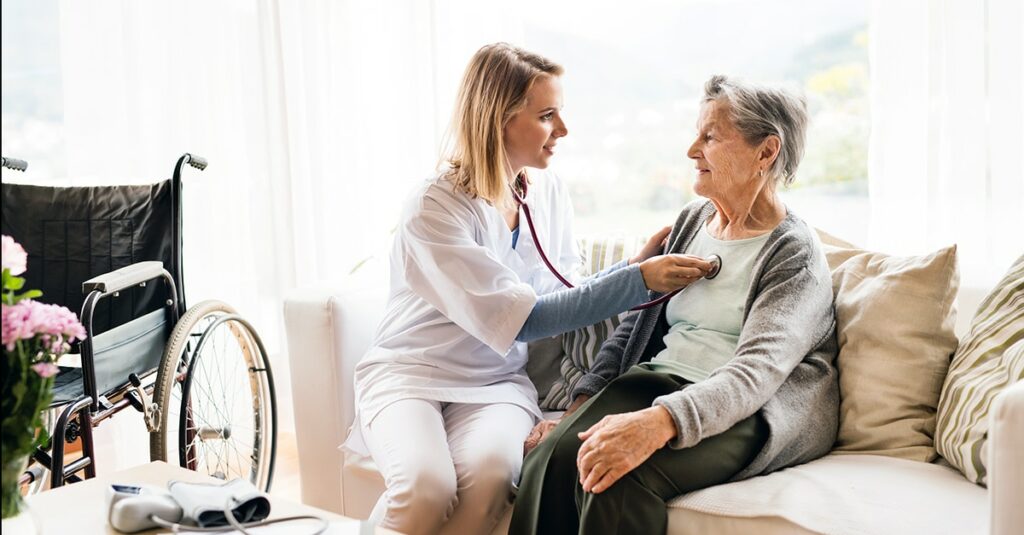 Home health doctor listening to heartbeat of resident