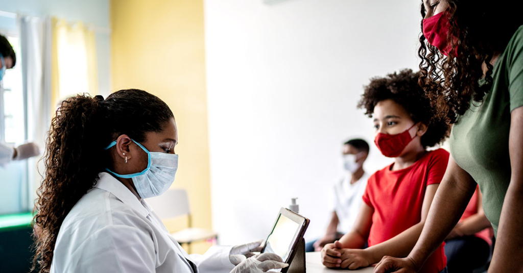 Doctor treating family in masks