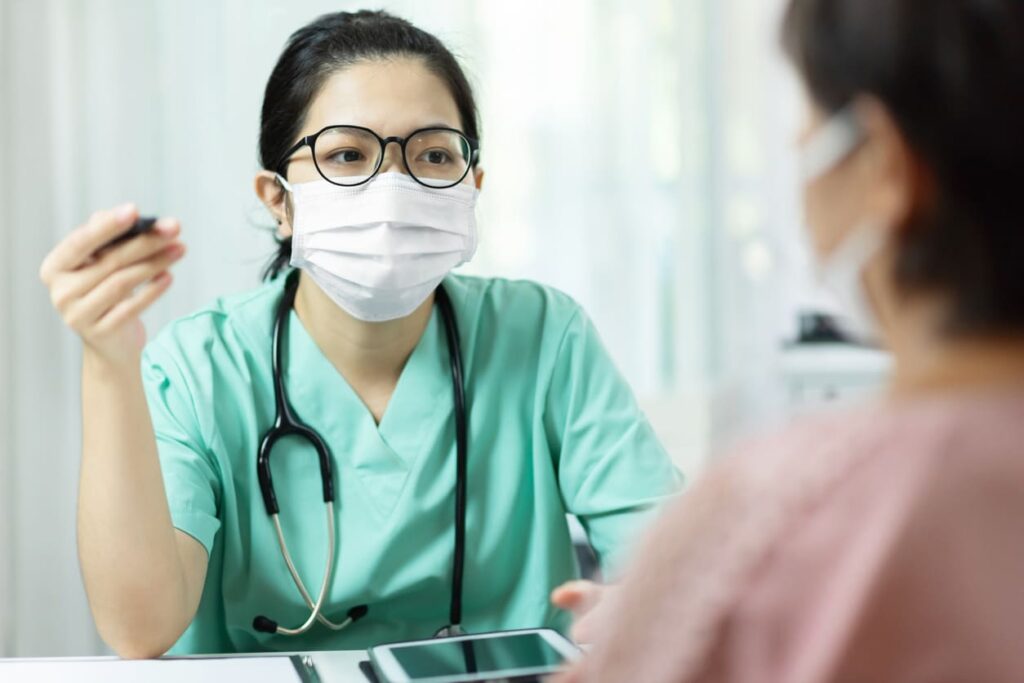 Care team members discussing care in masks