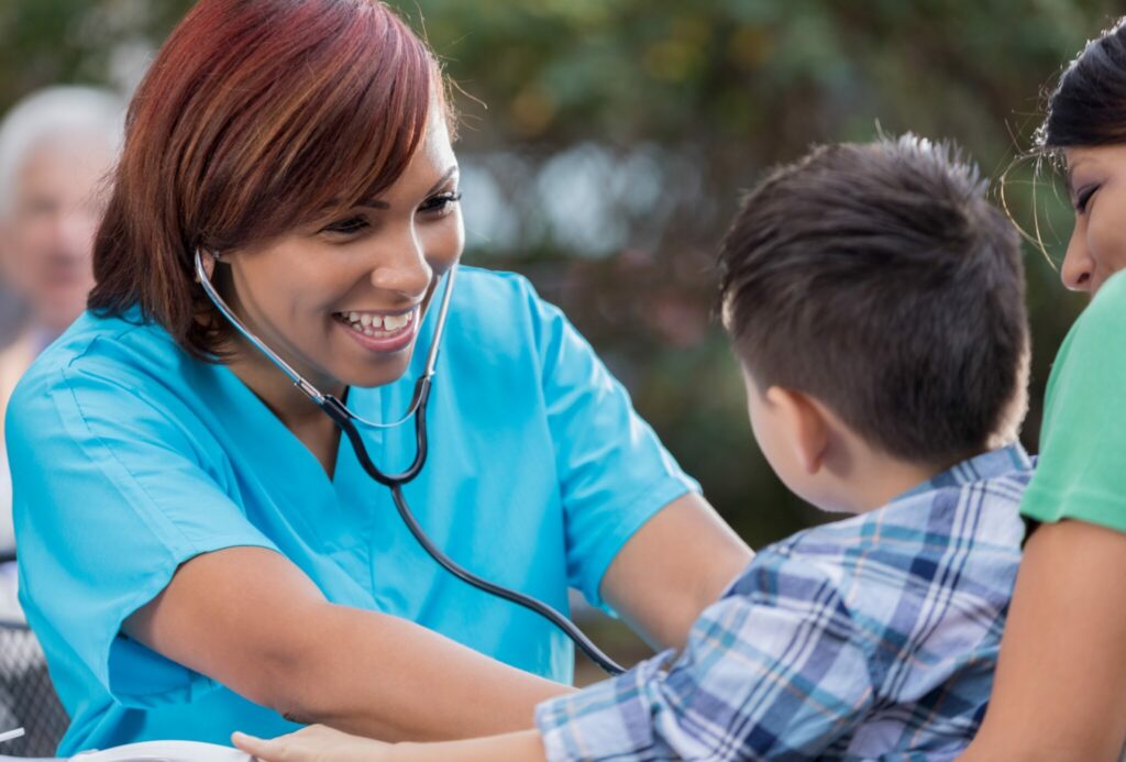 Physician gladly checking heartbeat of child.