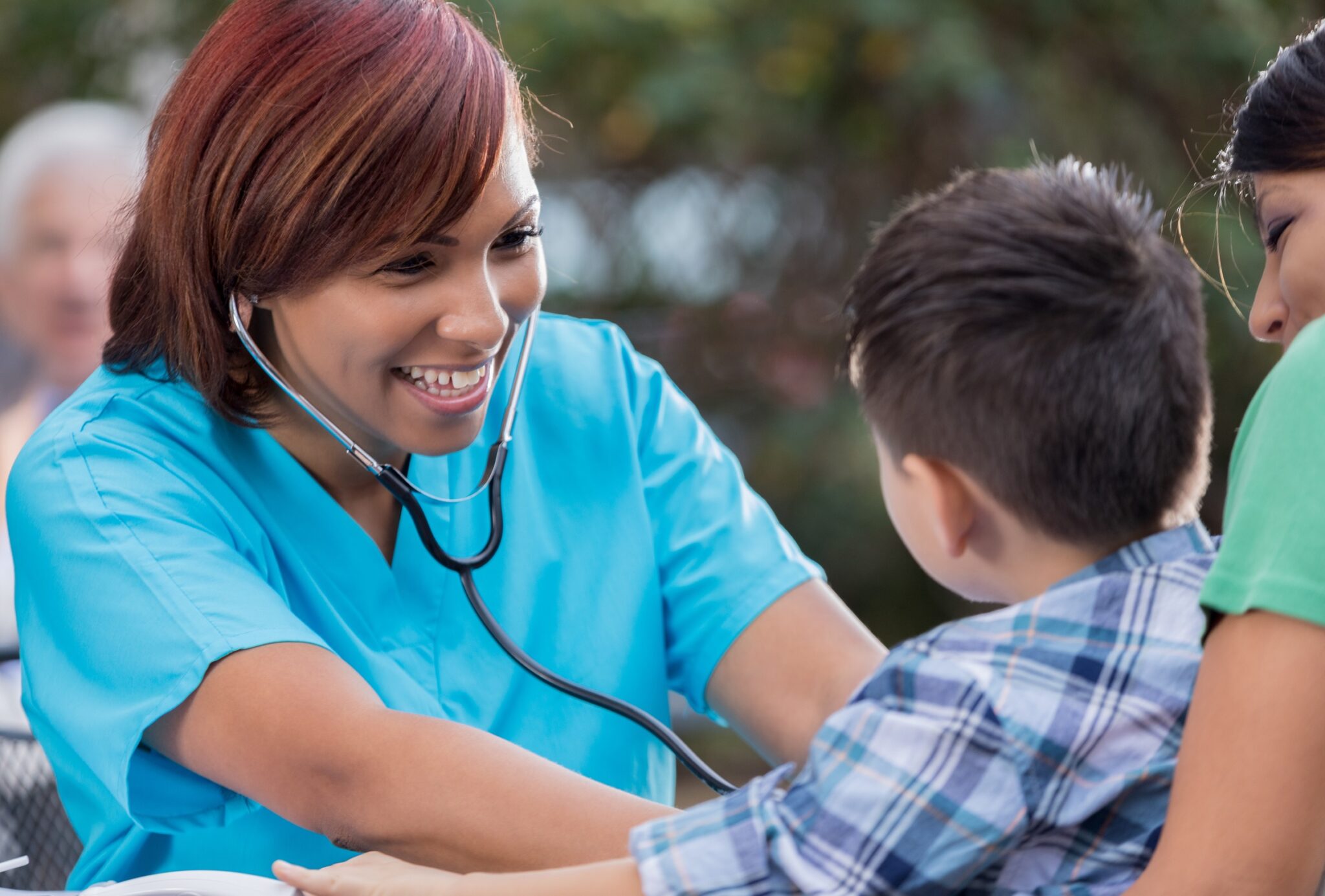 Physician gladly checking heartbeat of child.