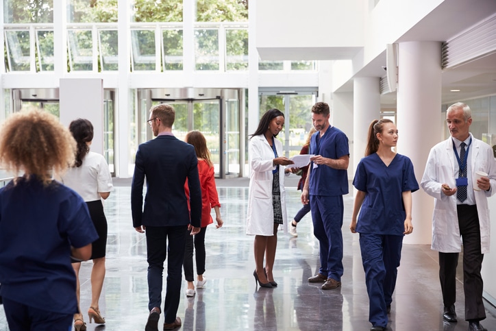 Staff in busy lobby area of modern hospital