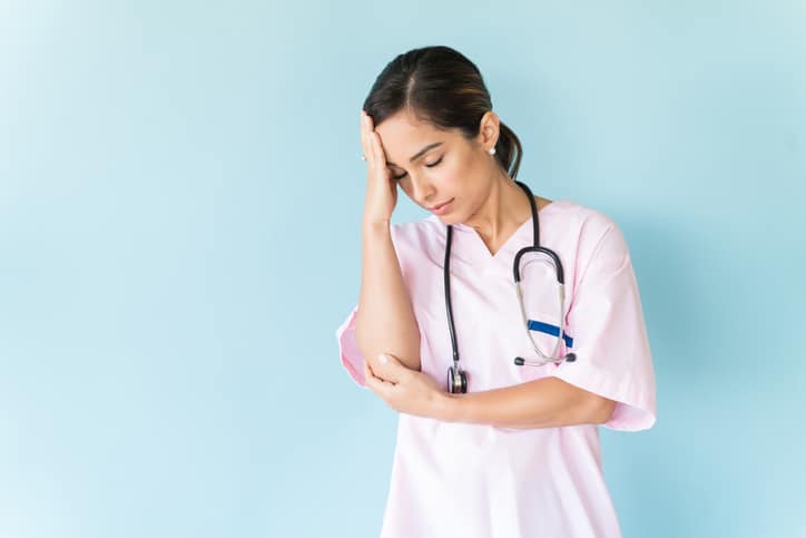 Stressed doctor in scrubs