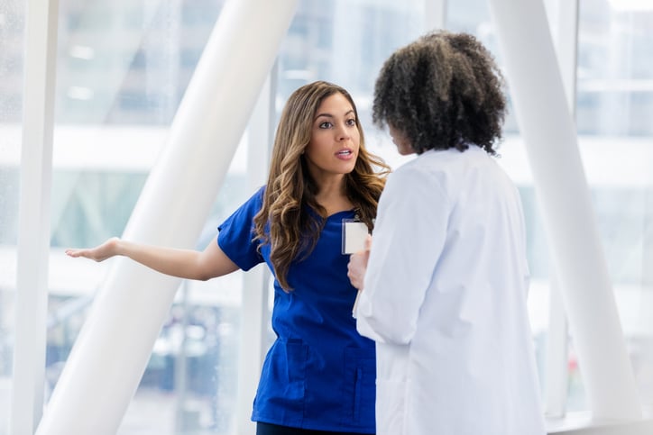 Upset nurse speaking to doctor