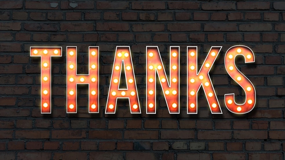Large "thank you" sign on brick wall