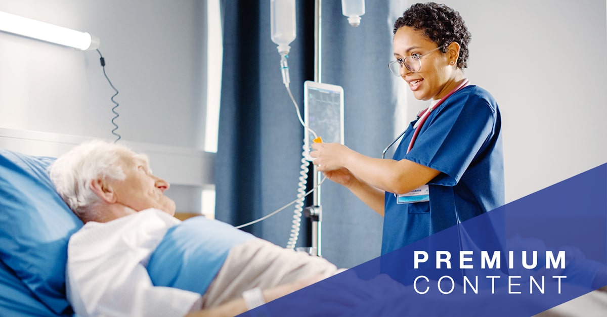 Nurse speaking to patient in hospital bed