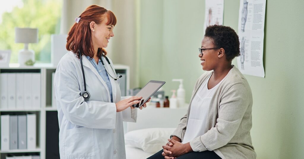 patient speaking to doctor in doctor's office