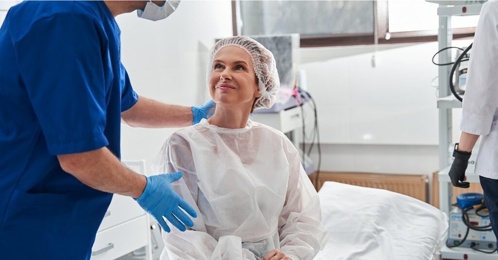 Man calming his patient before the gastroscopy at the modern clinic