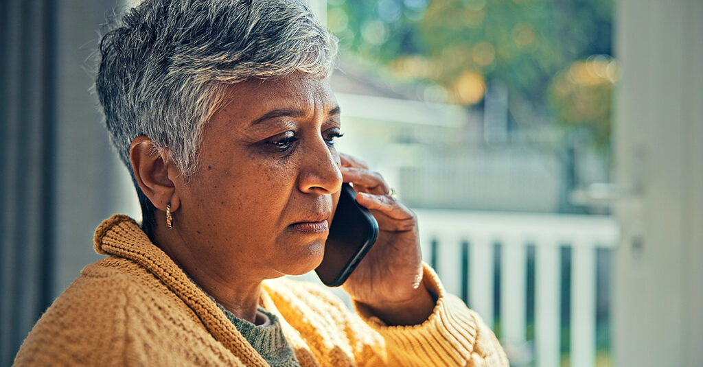 Concerned older woman talking on phone.