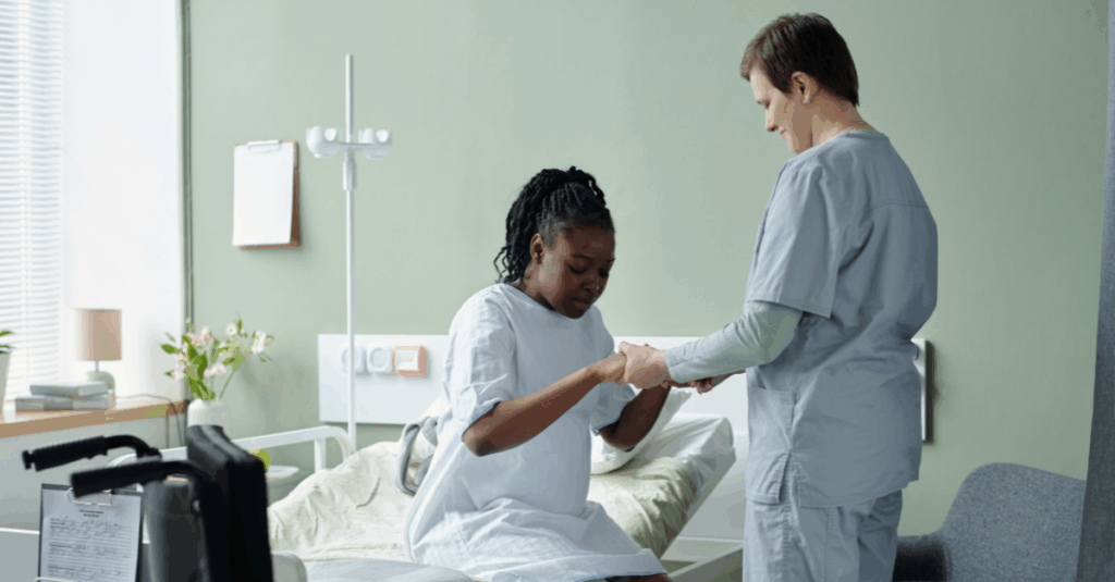 Care team worker treating patient in hospital bed