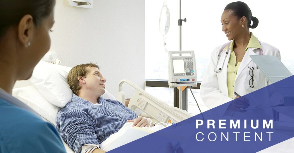 doctor and nurse speaking to patient in hospital bed